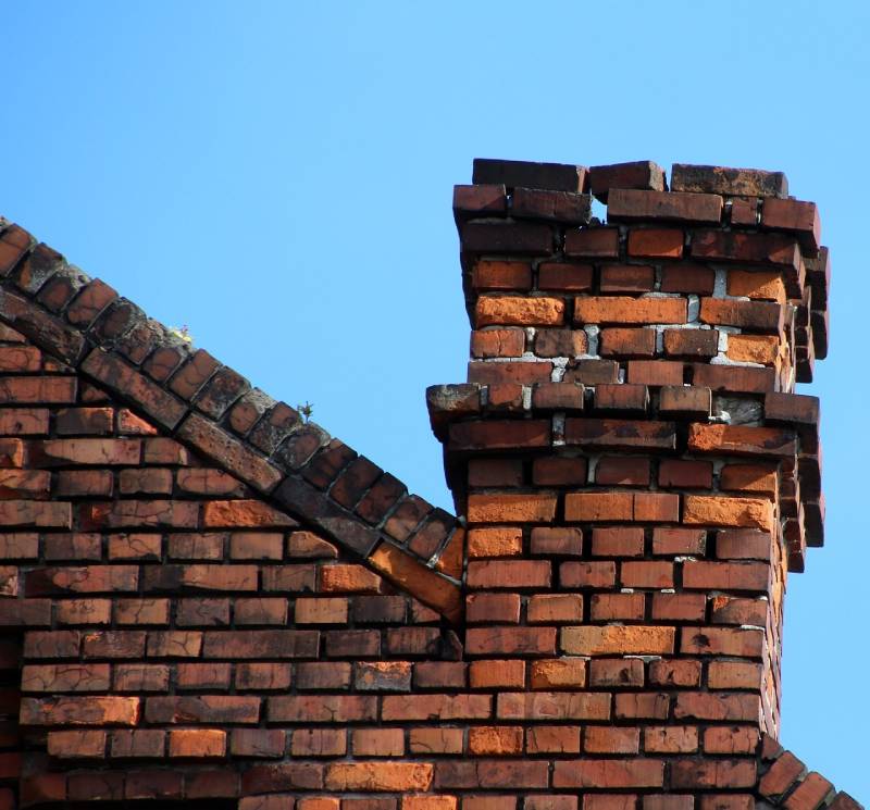 Signs Your Whitman Home Needs a Chimney Inspection Blog Article - Damaged chimney on an Whitman home showing cracks and missing mortar